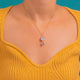 Moonstone charm worn, wider view