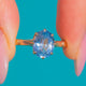 Oval light-blue Topaz solitaire in a Gold claw setting