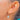 Opal earring worn to show its drop and hook fitting